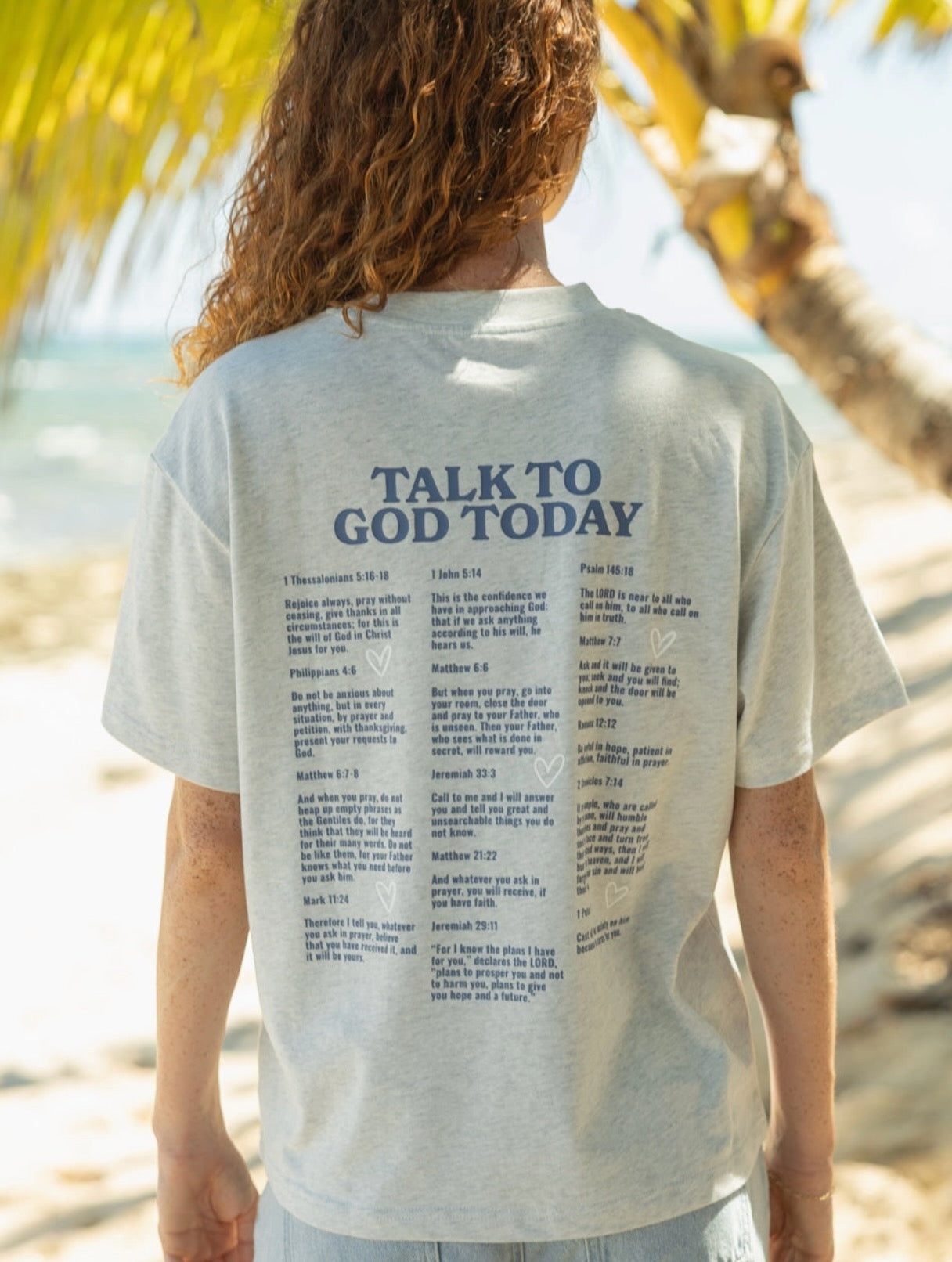 Model wearing oversized Talk To God Christian graphic tee